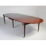 A 19th century Regency style mahogany extending dining table, the D-ends extending to enclose