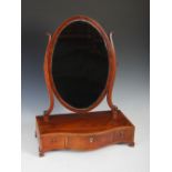 A 19th century mahogany boxwood and ebony lined dressing table mirror, the oval mirror plate