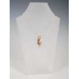 LAUREL JEWELLERY, A 9 carat yellow gold pendant, formed as a half matt/half polished leaf motif,