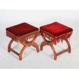 A pair of Victorian Gothic oak X-frame stools, the velvet upholstered rectangular tops with brass