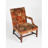 A George III mahogany Gainsborough chair, the velvet upholstered back, arms and seat with brass