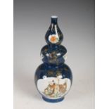 A Chinese porcelain powder blue ground triple gourd vase, late 19th/early 20th century, decorated