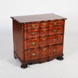 A 19th century Continental yew wood chest, the shaped rectangular top with moulded edge and