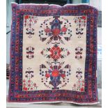 A Persian rug, late 19th/early 20th century, the rectangular sand coloured ground centred with a