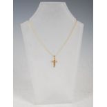 STUART GELNER, A 9 carat yellow gold cross pendant, set with six faceted square citrines, on 9 carat