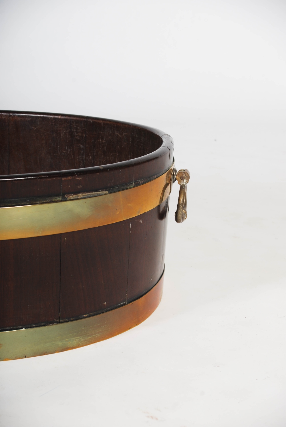 A George III mahogany and brass bound oval shaped cellarette, with brass drop handles to the - Image 3 of 6