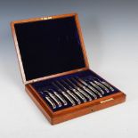 A cased set of twelve Victorian electroplated fruit knives and forks, the handles of pistol shape,