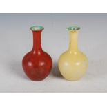 A pair of Chinese porcelain monochrome bottle vases, late 19th/early 20th century, one yellow, the
