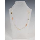 TEZER DESIGN, A 14 carat yellow gold necklace, with vari-sized tapering oval spacers in matt and