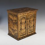 A Chinese export black and gilt lacquer table cabinet, Qing Dynasty, the rectangular top decorated