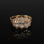 A yellow metal and diamond cluster ring, centred with a raised oval brilliant cut diamond, estimated