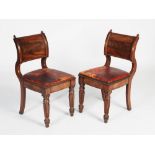A pair of William IV mahogany and brass inlaid hall chairs, the convex and concave uprights