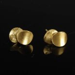 TEZER, A pair of 14 carat yellow gold earrings formed as two overlapping matt ovals, Stamped: TEZER,
