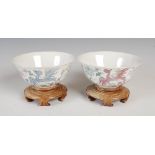 A pair of Chinese porcelain footed bowls, four character Qianlong mark but later, decorated with