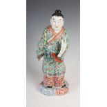 A Chinese porcelain famille rose figure of a scholar, late 19th/early 20th century, 34cm high.