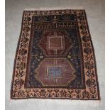 An Afghan Belouch prayer mat, early 20th century, the rectangular blue ground decorated with two