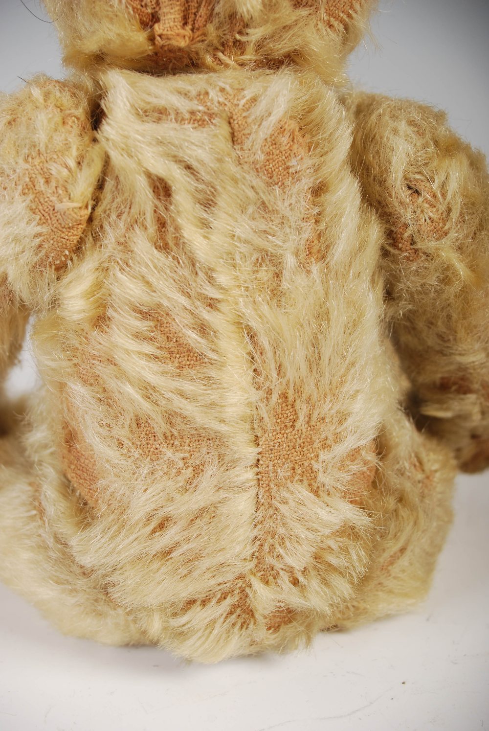 An early 20th century teddy bear, possibly Steiff, with golden mohair and brown/ black button boot - Image 6 of 10