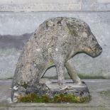 A reconstituted stone wild boar garden ornament, modelled sitting on a rectangular plinth.