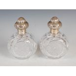 A pair of Victorian silver mounted cut glass dressing table bottles and stoppers, London 1892,