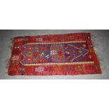 A Kelim rug, 20th century, the abrashed blue ground decorated with stylised flower head motifs,