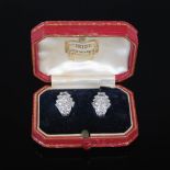 A pair of early 20th century Art Deco white metal and diamond earrings by Cartier, each clip earring