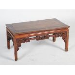 A Chinese dark wood Kang table, late 19th/early 20th century, the rectangular panelled top above a