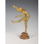 Claire Colinet (1880-1950) - A gilt bronze figure of a nude juggler, on circular stepped marble