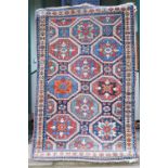 A Kazak rug, late 19th century, the dark blue rectangular field centred with nine octagonal shaped