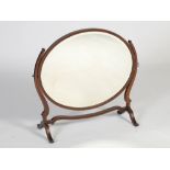 A late 19th/early 20th century mahogany and chequer banded dressing table mirror, the oval mirror