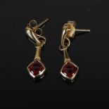 PRISM DESIGN, A pair of 9 carat yellow gold and garnet cabochon lozenge-shaped drop earrings,