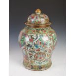 A Chinese porcelain Canton famille rose temple jar and cover, Qing Dynasty, decorated with