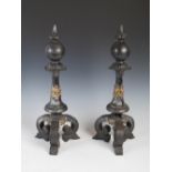 A pair of late 19th/early 20th century cast iron and brass andirons, the ball shaped finials above a