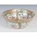 A Chinese porcelain famille rose Canton punch bowl, Qing Dynasty, decorated with panels of