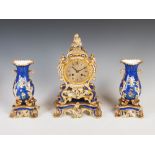 A late 19th century Paris Ed Honore porcelain clock garniture in the Rococo style, the clock with