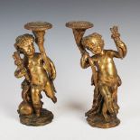 A pair of 19th century ormolu putti, both modelled standing on one leg holding a cornucopia vase