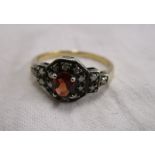 Gold garnet & diamond set ring