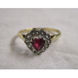 Gold ring set with heart shaped ruby