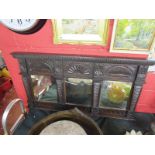 Heavily carved oak overmantle mirror