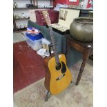 Tanglewood acoustic guitar on stand
