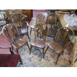 Set of six wheel back dining chairs to include 2 carvers