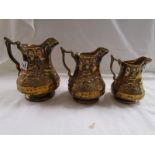 3 graduated gilt jugs