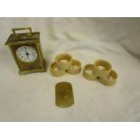 Small carriage clock, set of six ivory napkin rings and onyx cartouche