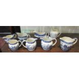 Collection of 8 blue and white jugs