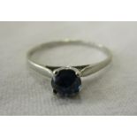 White gold ring set with upturned blue sapphire