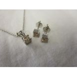 Pair of 18ct white gold princess cut diamond earrings with matching pendant on chain, each diamond