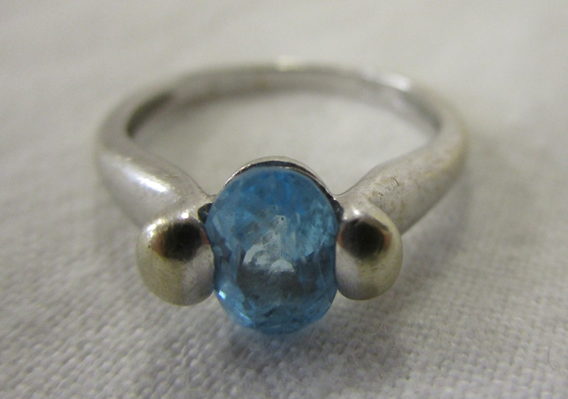 White gold blue topaz set ring