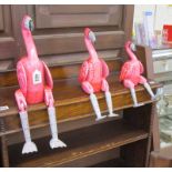 3 graduated and articulated flamingos