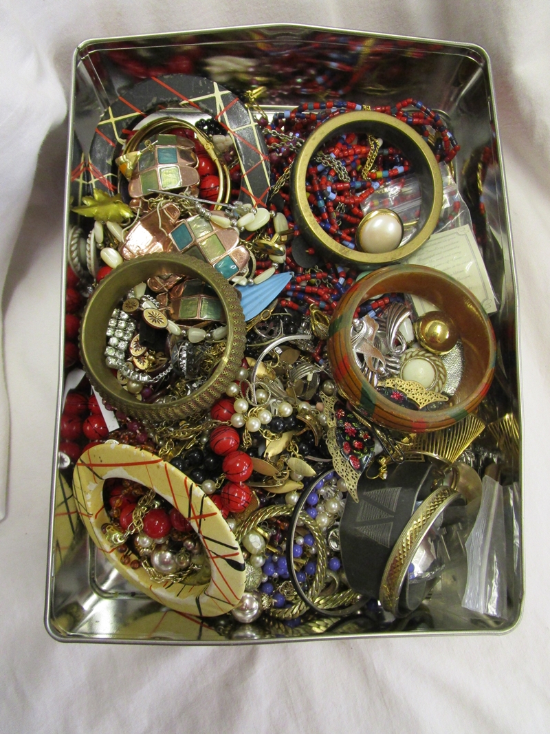 Tin of costume jewellery