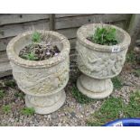 2 stone planters adorned with cherubs
