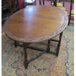 Oak gateleg table with carved edges